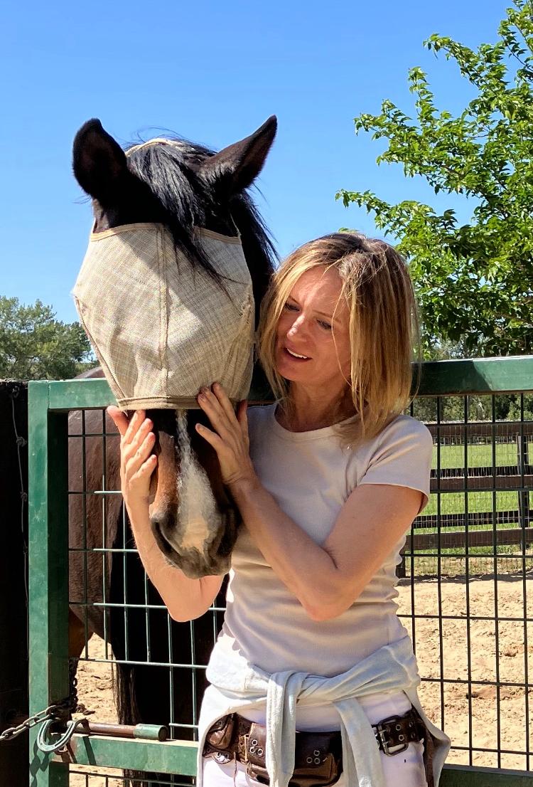 Woman hugging a white horse around its neck — deep trust and bond between human and animal. about Southern California Pet Sitting