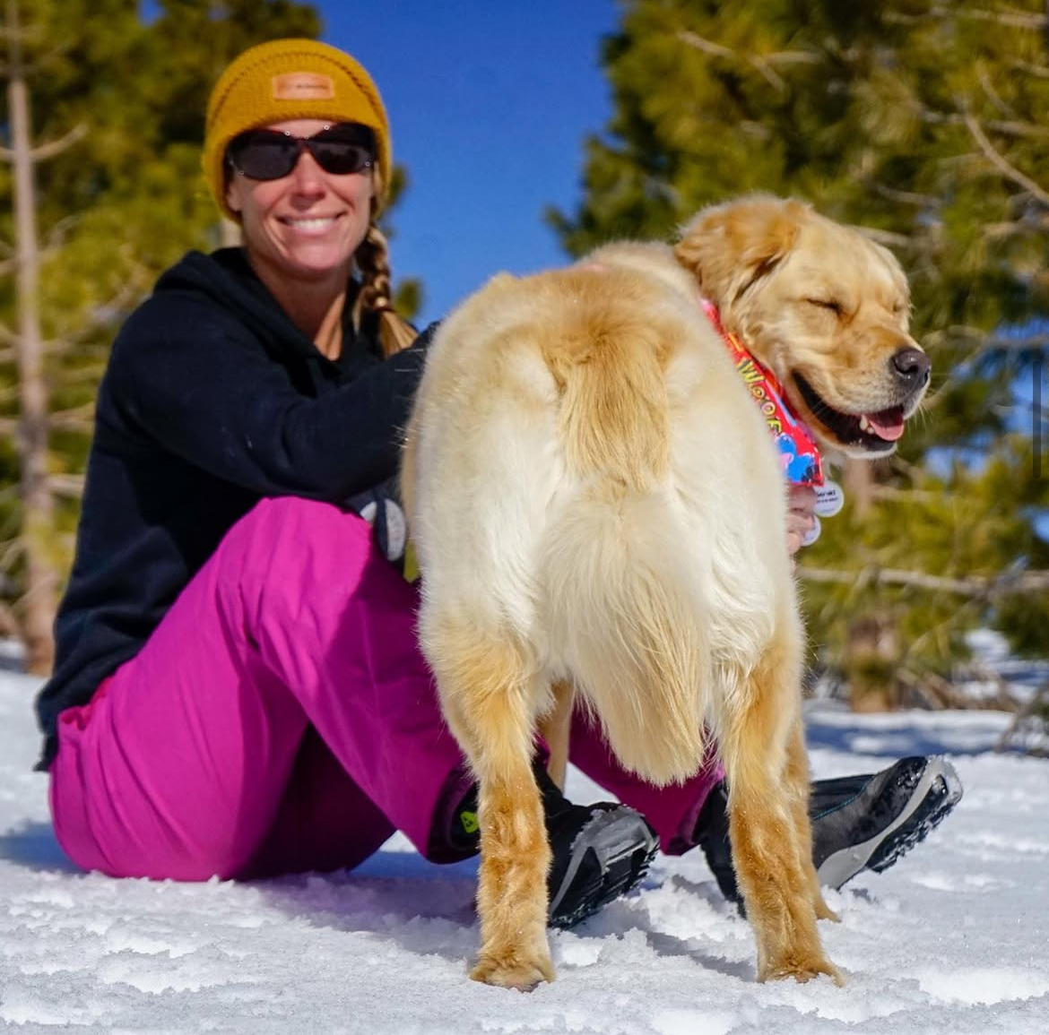 Aeray with smiling retriever in winter gear – experienced cold-climate sitting. Southern California Pet Sitting 